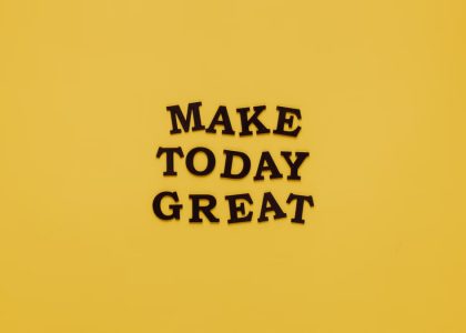 Simple and motivational quote 'Make Today Great' on a minimalist yellow background for inspiration.